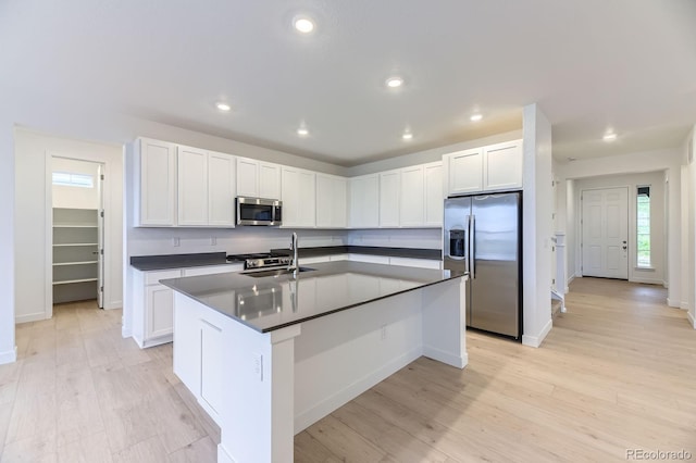7440 S Yank Ct, Littleton, CO 80127 - kitchen with appliances with stainless steel finishes, dark countertops, white cabinets, and recessed lighting