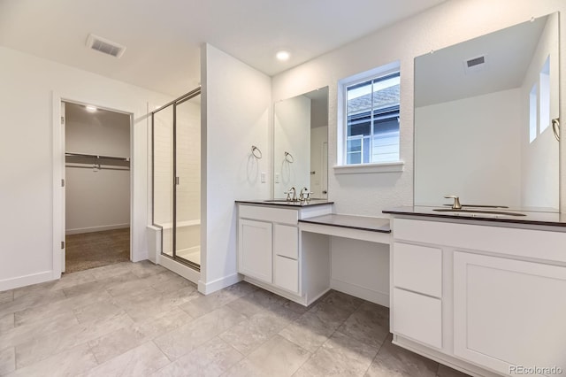 7440 S Yank Ct, Littleton, CO 80127 - full bath with a stall shower, two vanities, and a walk in closet