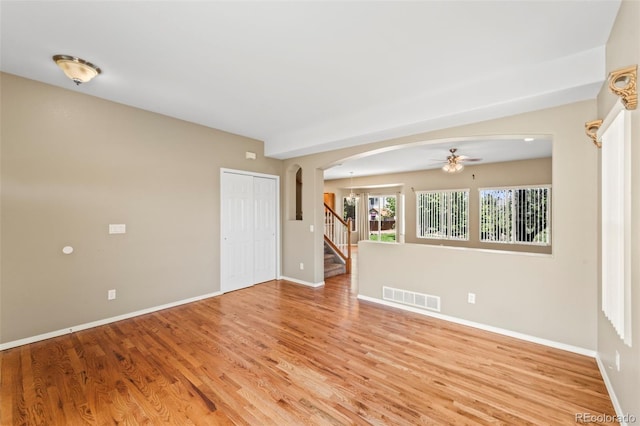 4960 Seton Pl, Colorado Springs, CO 80918 - unfurnished room featuring arched walkways, light wood-style flooring, ceiling fan, and stairway