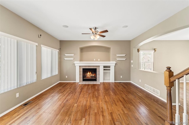 4960 Seton Pl, Colorado Springs, CO 80918 - unfurnished living room featuring a tile fireplace, a ceiling fan, wood finished floors, and stairway