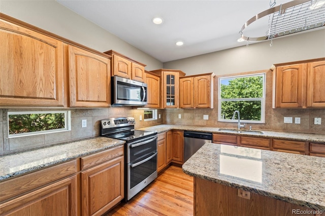 4960 Seton Pl, Colorado Springs, CO 80918 - kitchen featuring stainless steel appliances, light wood finished floors, light stone counters, decorative backsplash, and recessed lighting