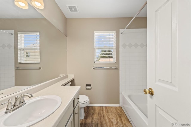 4960 Seton Pl, Colorado Springs, CO 80918 - full bath with vanity, plenty of natural light, shower / tub combination, and wood finished floors