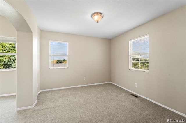 4960 Seton Pl, Colorado Springs, CO 80918 - unfurnished room with healthy amount of natural light, carpet, and arched walkways