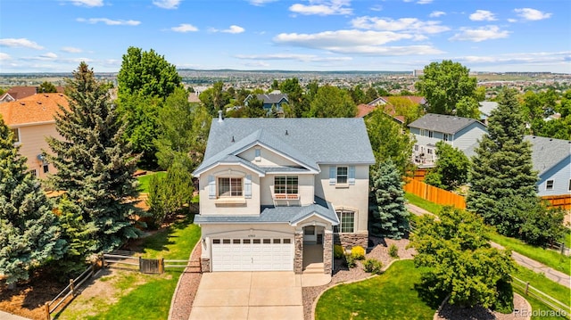 4960 Seton Pl, Colorado Springs, CO 80918 - view of front of house with stone siding, driveway, a garage, stucco siding, and roof with shingles