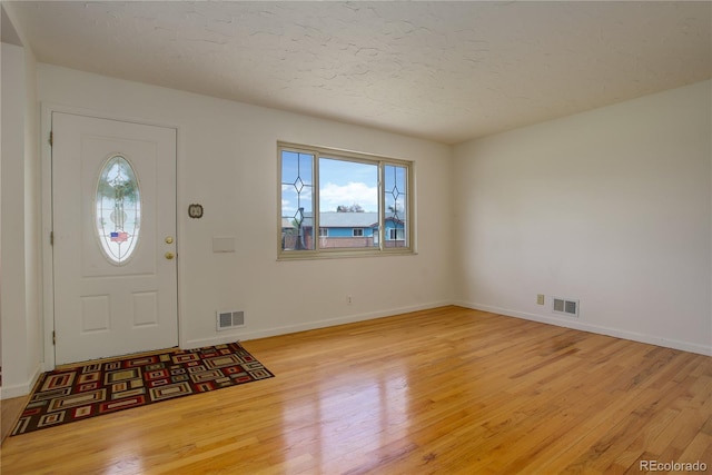 entryway with visible vents, baseboards, and light wood-style flooring