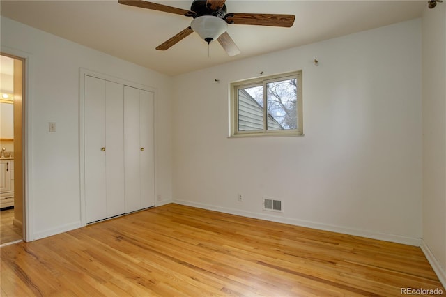 unfurnished bedroom with baseboards, visible vents, a sink, a closet, and light wood-type flooring