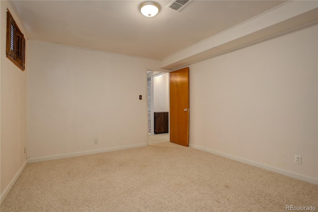 carpeted spare room with visible vents and baseboards