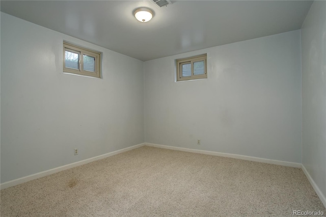 below grade area featuring baseboards and carpet flooring