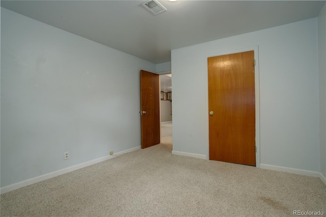 unfurnished bedroom featuring visible vents, carpet floors, and baseboards