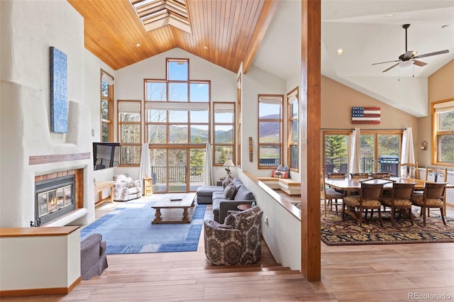 1107 Penstemon Rd, Dillon, CO 80435 - living room with a tiled fireplace, a wealth of natural light, high vaulted ceiling, and wood ceiling
