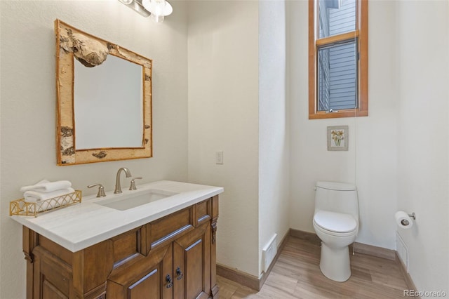 1107 Penstemon Rd, Dillon, CO 80435 - bathroom featuring vanity, baseboards, toilet, visible vents, and wood finished floors