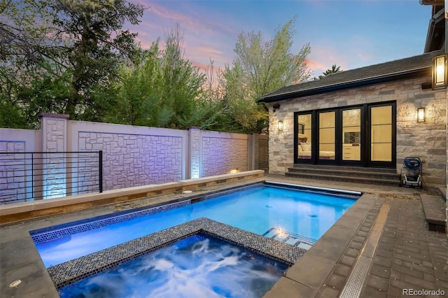 view of pool with an in ground hot tub, a fenced in pool, and a fenced backyard
