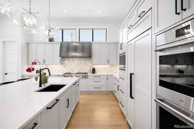 kitchen featuring appliances with stainless steel finishes, a sink, recessed lighting, tasteful backsplash, and pendant lighting