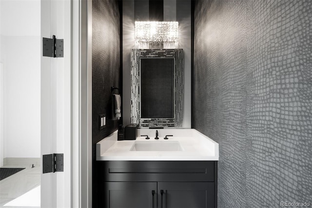 bathroom with a chandelier and vanity