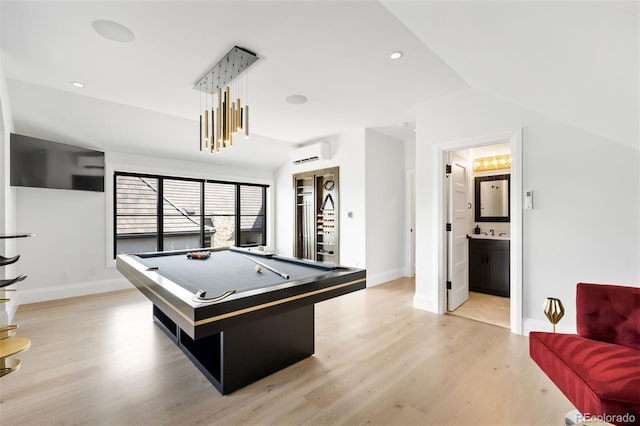 rec room featuring billiards, a wall mounted AC, vaulted ceiling, and light wood-style flooring