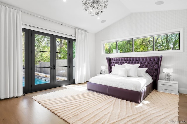 bedroom with french doors, access to exterior, vaulted ceiling, wood finished floors, and wallpapered walls