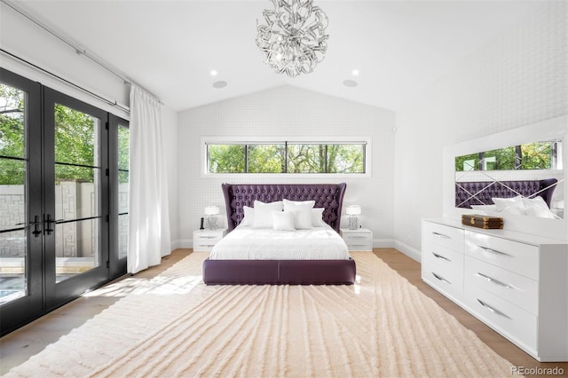 bedroom featuring access to outside, lofted ceiling, multiple windows, and an inviting chandelier