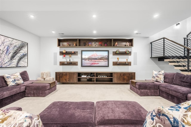 carpeted living room with stairway and recessed lighting
