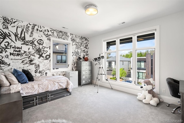 bedroom with carpet floors, baseboards, and visible vents
