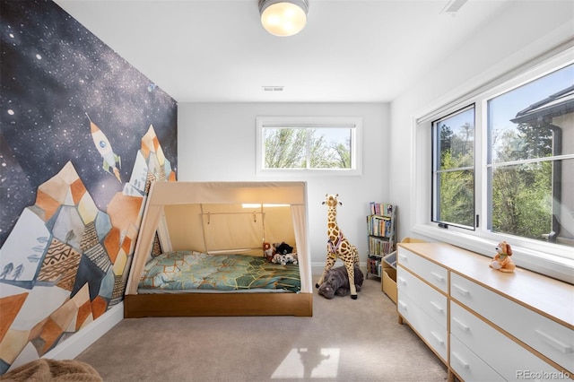 carpeted bedroom featuring baseboards and visible vents