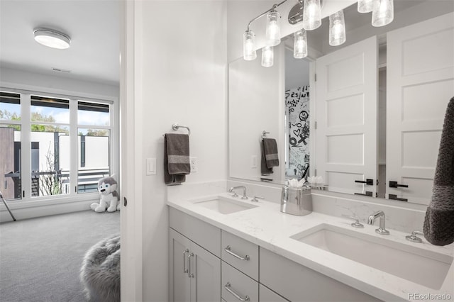 full bathroom featuring a sink and double vanity
