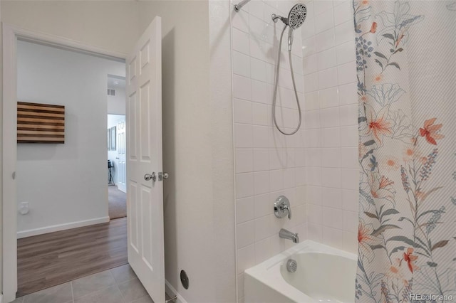 16841 Askins Loop Unit 101, Parker, CO 80134 - bathroom with shower / bath combo with shower curtain and tile patterned floors