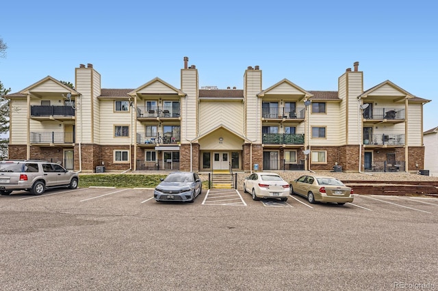 view of building exterior with uncovered parking