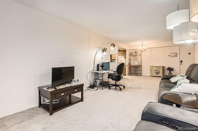 living room featuring carpet and a chandelier