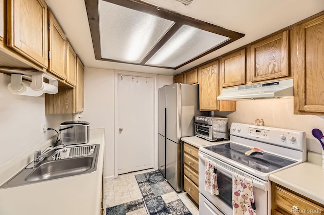 kitchen featuring a sink, a toaster, freestanding refrigerator, white range with electric stovetop, and under cabinet range hood