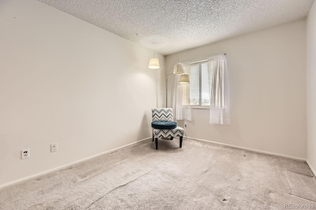 unfurnished room with baseboards, carpet flooring, and a textured ceiling