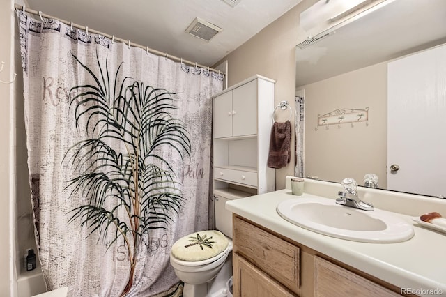 bathroom featuring toilet, visible vents, and vanity