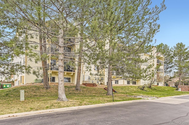 obstructed view of property featuring a front yard