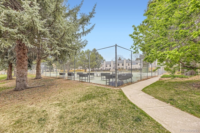 surrounding community with a lawn and fence