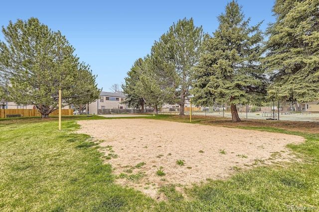 view of community with fence and a yard