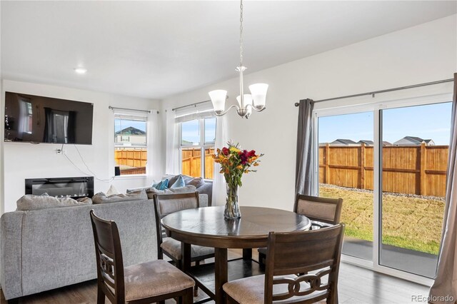 4125 Marble Dr, Longmont, CO 80504 - dining room with wood finished floors, a chandelier, and recessed lighting