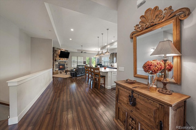 corridor with dark wood-style floors, recessed lighting, and baseboards