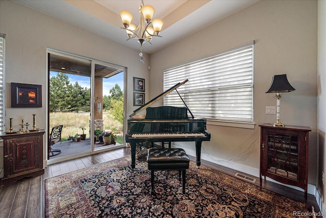 sitting room featuring a chandelier, wood finished floors, and visible vents