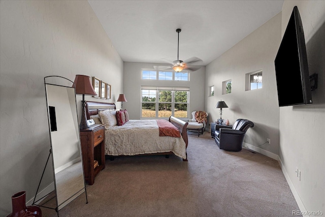 carpeted bedroom with a towering ceiling, ceiling fan, and baseboards