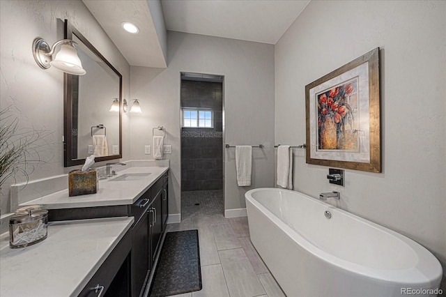 bathroom with vanity and a bath