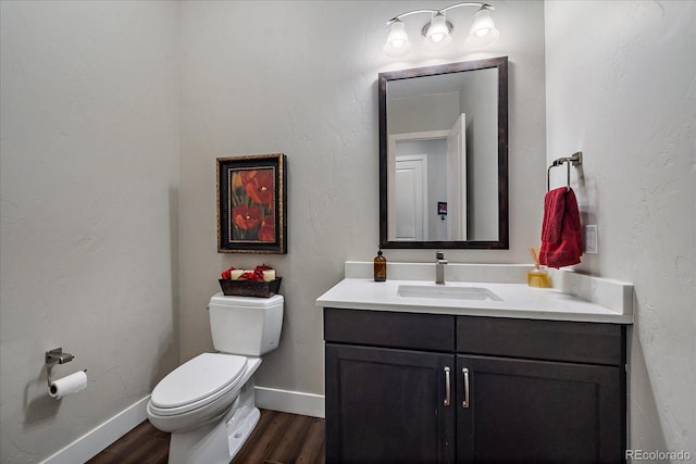 bathroom featuring vanity, toilet, and hardwood / wood-style flooring