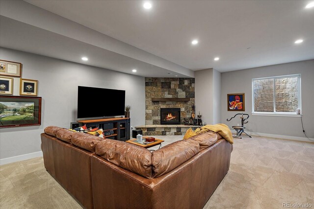 living room with a stone fireplace and light colored carpet