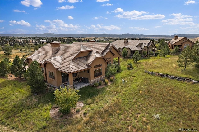 birds eye view of property with a mountain view