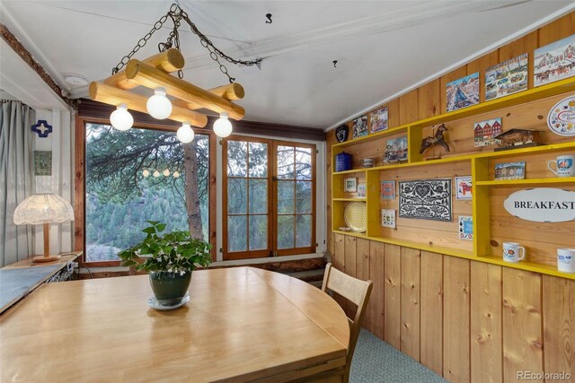 16048 Old Stagecoach Rd, Pine, CO 80470 - dining room with healthy amount of natural light, wood walls, and ornamental molding