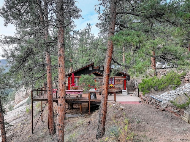 16048 Old Stagecoach Rd, Pine, CO 80470 - rear view of house with a deck and a view of trees
