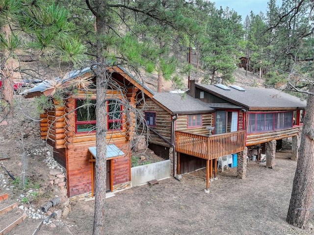 16048 Old Stagecoach Rd, Pine, CO 80470 - back of property featuring a wooden deck, a shingled roof, and log siding