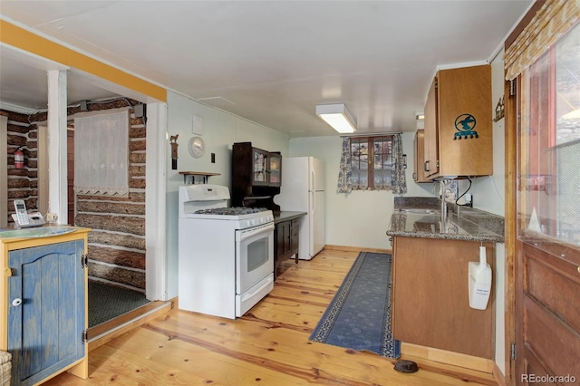 16048 Old Stagecoach Rd, Pine, CO 80470 - kitchen featuring white appliances, light wood-type flooring, a sink, and brown cabinetry