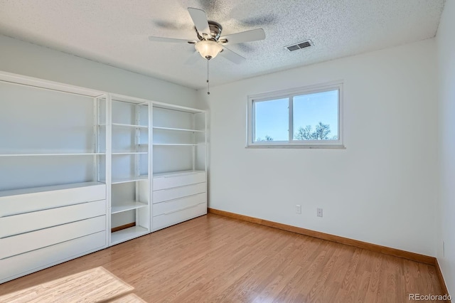 16259 W 10th Ave Unit J5, Golden, CO 80401 - unfurnished bedroom with baseboards, wood finished floors, a textured ceiling, and a ceiling fan