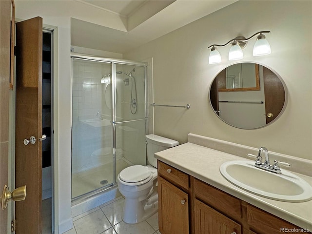 bathroom featuring vanity, a shower with shower door, toilet, and tile patterned flooring