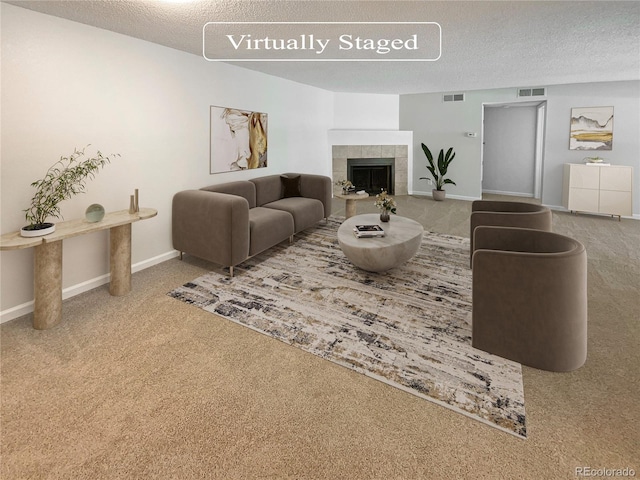 living room with carpet flooring, a textured ceiling, and a fireplace