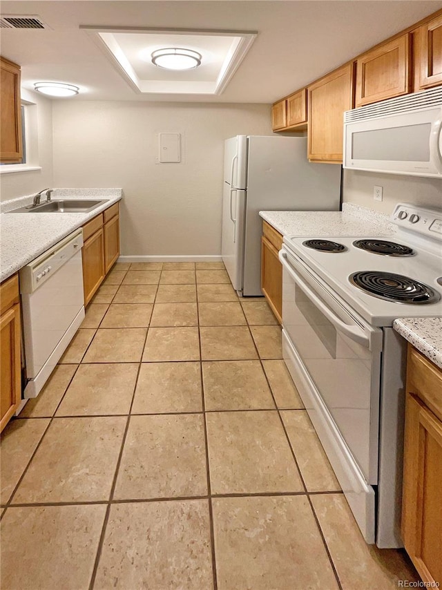 kitchen with white appliances, light tile patterned flooring, and sink